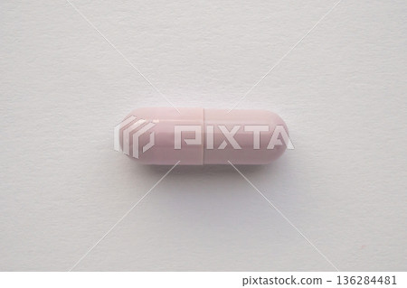 Purple medicine pill capsule on white background 136284481