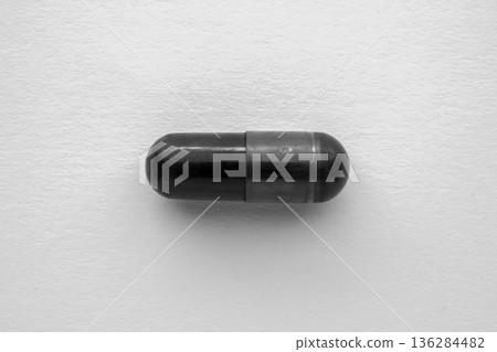 Black medicine pill activated charcoal capsule on white background Black medicine pill activated charcoal capsule on white background 136284482
