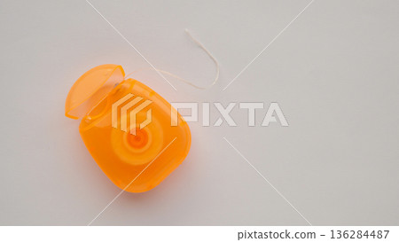 dental floss in case on white background 136284487