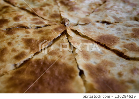 Close-up of sliced Lobiani, a traditional Georgian flatbread stuffed with spiced mashed beans 136284629