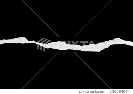 Ripped torn paper edges isolated on black background 136284674