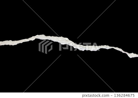 Ripped torn paper edges isolated on black background 136284675
