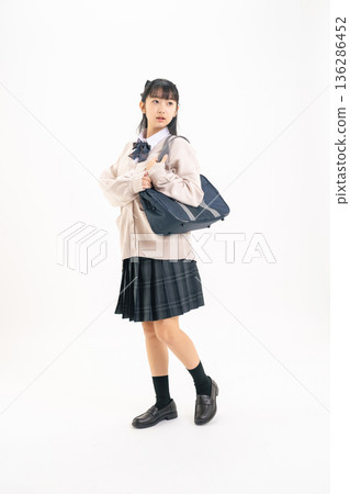 Full-body photo of a female student in a walking uniform 136286452