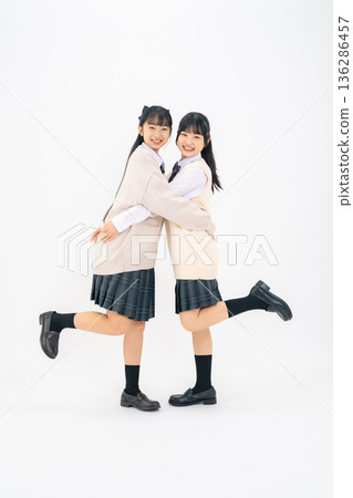 Full-body photo of two female students standing close together Full-body photo of two female students standing close together 136286457