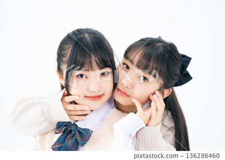 Two female students standing close together Two female students standing close together 136286460