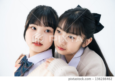 Two female students standing close together 136286462