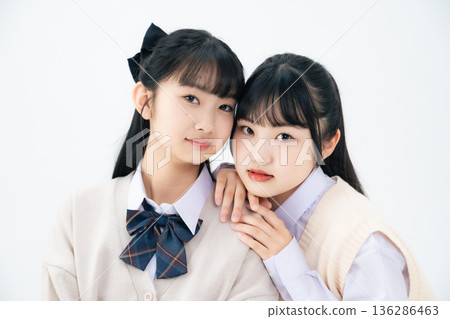 Two female students standing close together Two female students standing close together 136286463