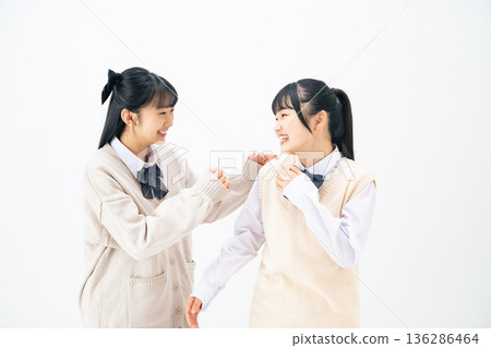 Two female students standing close together Two female students standing close together 136286464