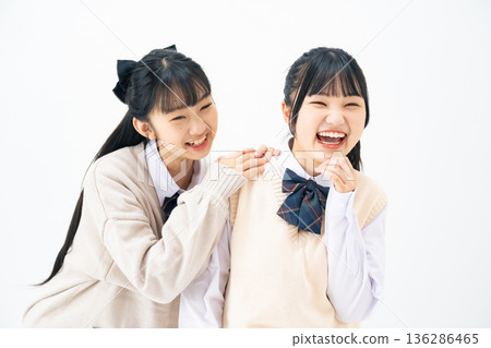 Two female students standing close together Two female students standing close together 136286465