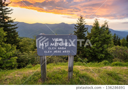 Road trip travel in Appalachian mountains at sunset. Mt. Mitchell Overlook on parkway and woods nature in summer season. Colorful forest in North Carolina Road trip travel in Appalachian mountains at sunset. Mt. Mitchell Overlook on parkway and woods nature in summer season. Colorful forest in North Carolina 136286891