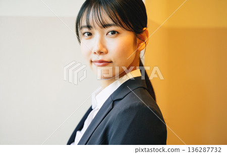 A young woman newly graduated in a recruitment suit 136287732