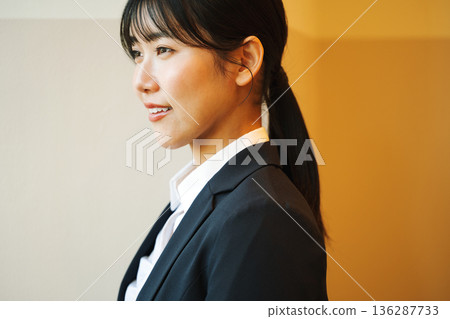 A young woman newly graduated in a recruitment suit A young woman newly graduated in a recruitment suit 136287733