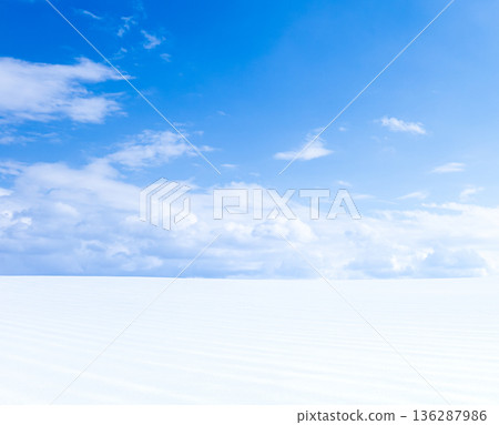 A simple landscape of snowy fields and blue skies on the hills of Biei, Hokkaido in midwinter 136287986