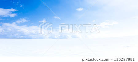 A simple landscape of snowy fields and blue skies on the hills of Biei, Hokkaido in midwinter 136287991