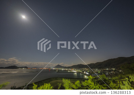 A beautiful starry sky over the sea in Yorishima Town, Asakuchi City, Okayama Prefecture, Japan 136288313