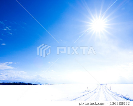 A packed snow icy road scene in Biei, Hokkaido, under the winter sun and blue sky A packed snow icy road scene in Biei, Hokkaido, under the winter sun and blue sky 136288932