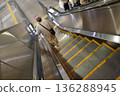 Old man going down the escalator 136288945