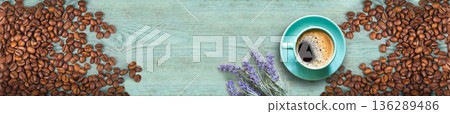 Top view of espresso cup with roasted coffee beans and lavender flowers on turquoise wooden background panoramic banner 136289486