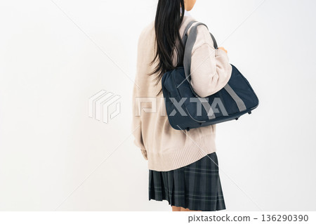 Female student walking with school bag Female student walking with school bag 136290390