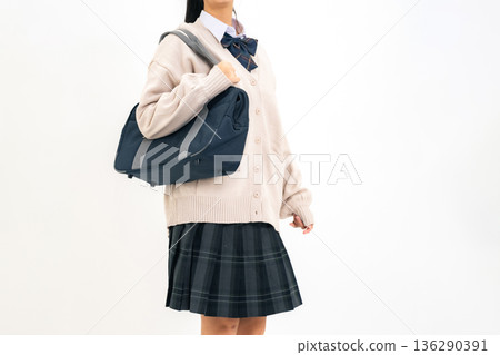 Female student walking with school bag Female student walking with school bag 136290391