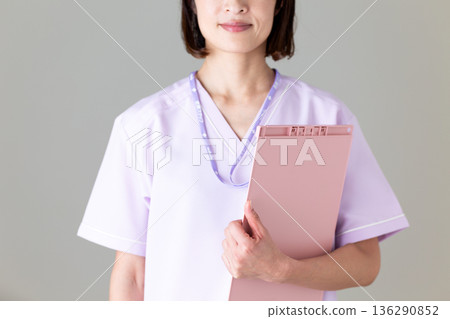 A middle-aged female nurse in a medical scrub A middle-aged female nurse in a medical scrub 136290852