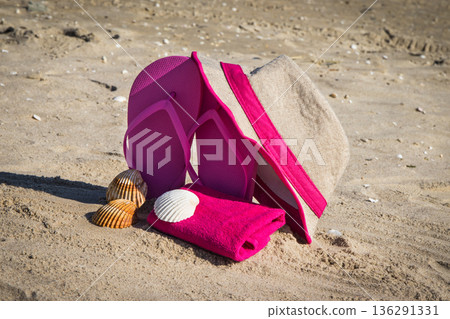 Accessories for relax on beach. Straw hat, flip flop and towel. Summertime Accessories for relax on beach. Straw hat, flip flop and towel. Summertime 136291331