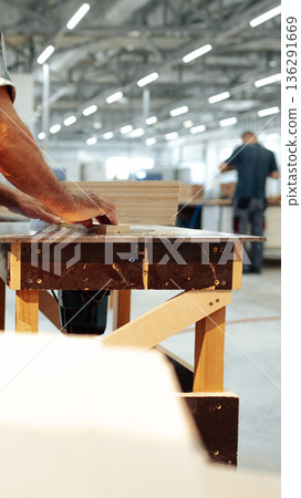 Woodworking process in a workshop with carpenters working on projects Woodworking process in a workshop with carpenters working on projects 136291669