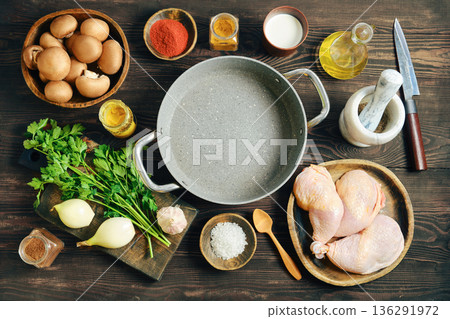 Raw ingredients for cooking chicken with mushrooms and vegetables on wooden table Raw ingredients for cooking chicken with mushrooms and vegetables on wooden table 136291972
