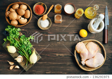 Raw chicken legs, mushrooms and vegetables - ingredients for cooking on wooden table with copy space Raw chicken legs, mushrooms and vegetables - ingredients for cooking on wooden table with copy space 136291973