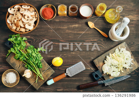 Ingredients and tools for cooking on wooden table with spices and vegetables 136291986