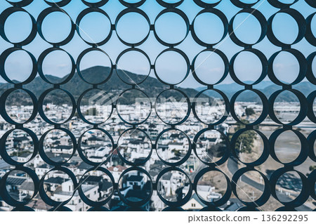 A bird's-eye view of the city and residential areas through a geometric circular pattern 136292295