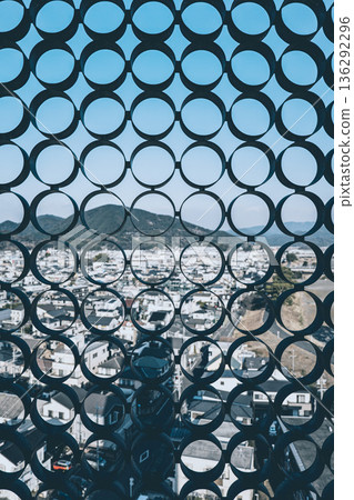 A bird's-eye view of the city and residential areas through a geometric circular pattern 136292296