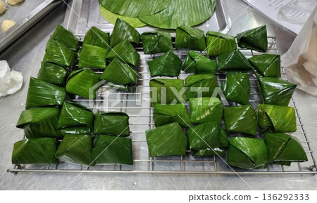 Traditional Thai Steamed Flour Desserts Wrapped in Banana Leaves Traditional Thai Steamed Flour Desserts Wrapped in Banana Leaves 136292333