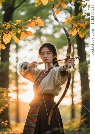 Ancient women draw their bows and shoot arrows in the forest 136293185
