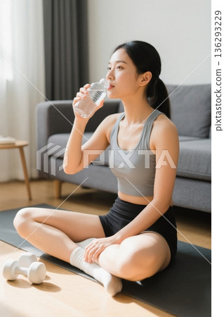 Home workout scene: women resting and drinking water 136293229