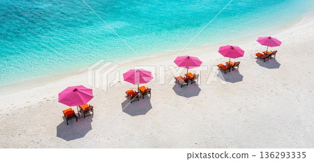 Relaxing aerial beach scenic pink umbrellas luxury resort getaway landscape ocean bay sandy shore tropical island summer vacation wallpaper background 136293335