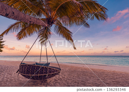 Beautiful sunset beach ocean view. Calm palm tree swing and hammock for honeymoon landscape Beautiful sunset beach ocean view. Calm palm tree swing and hammock for honeymoon landscape 136293346