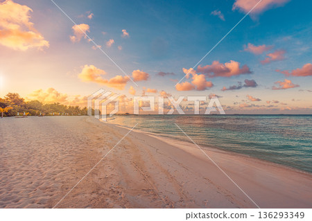 Amazing Maldives sunset beach landscape. Tropical ocean view and sandy shore summer scenery Amazing Maldives sunset beach landscape. Tropical ocean view and sandy shore summer scenery 136293349