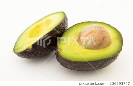 halved avocado with bone on white background 136293747