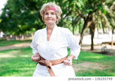 Old woman in kimono training in park Old woman in kimono training in park 136293749