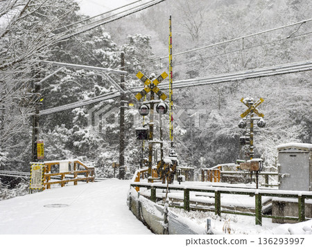Old railroad crossing covered in snow Old railroad crossing covered in snow 136293997
