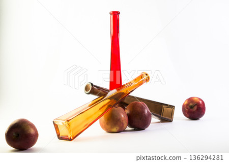 Still life of colored glass bottles on a white background 136294281