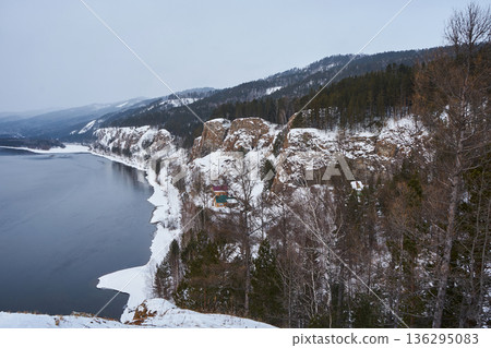 Yenisei river flowing next to snow covered cliffs at Karaulnenskoye Highlands near Krasnoyarsk, Russia. Winter landscape of Siberian nature. Yenisei river flowing next to snow covered cliffs at Karaulnenskoye Highlands near Krasnoyarsk, Russia. Winter landscape of Siberian nature. 136295083