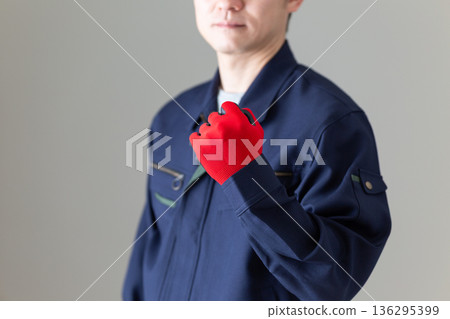Middle-aged male businessman in work clothes making a fist pump Middle-aged male businessman in work clothes making a fist pump 136295399