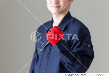 Middle-aged male businessman in work clothes making a fist pump Middle-aged male businessman in work clothes making a fist pump 136295400