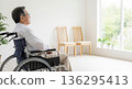 A back view of a senior man in a wheelchair looking out the window. An image of a peaceful life in a nursing home or barrier-free housing. 136295413