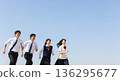 Four high school students, both boys and girls, run with smiles under the blue sky. This refreshing advertising material evokes images of youth, hope, the future, and education. 136295677
