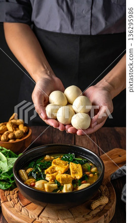 A close-up shot of fresh, leafy saka-saka being prepared, showing the vibrant green colors and rich texture A close-up shot of fresh, leafy saka-saka being prepared, showing the vibrant green colors and rich texture 136295986