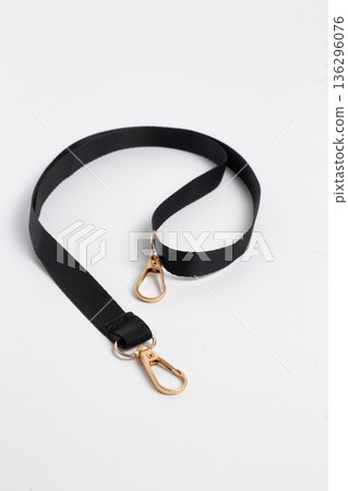 Black Fabric Lanyard Strap with Gold Metal Swivel Snap Hooks on White Background Flat Lay Black Fabric Lanyard Strap with Gold Metal Swivel Snap Hooks on White Background Flat Lay 136296076