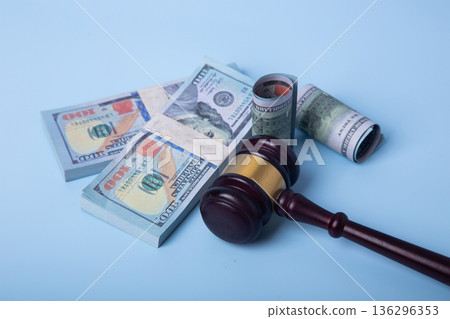 Gavel and money representing legal financial settlement 136296353